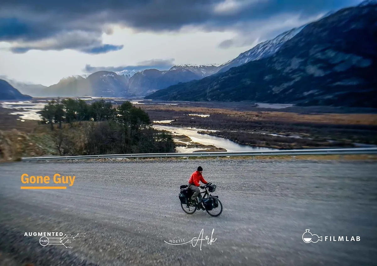 Title card for Gone Guy: a cyclist in a red jacket rides a gravel road through a mountain valley, with the producers' logos along the bottom.